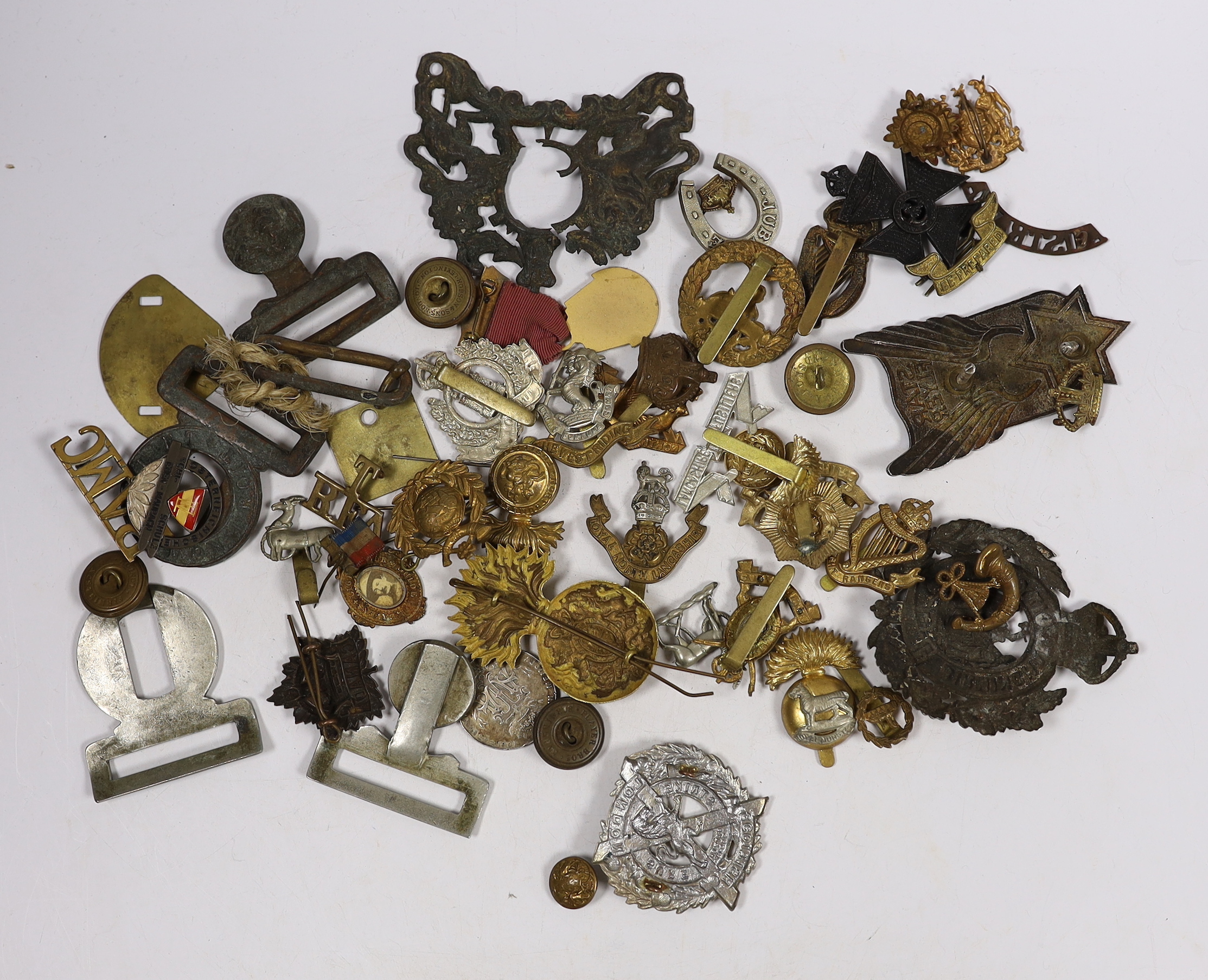 Eighteen military cap badges including Northumberland Fusiliers, East Yorkshire, SWB, the Suffolk Regiment, the Lancashire Fusiliers, Connaught Rangers, North Irish Horse, the West Riding, together with a number of shoul